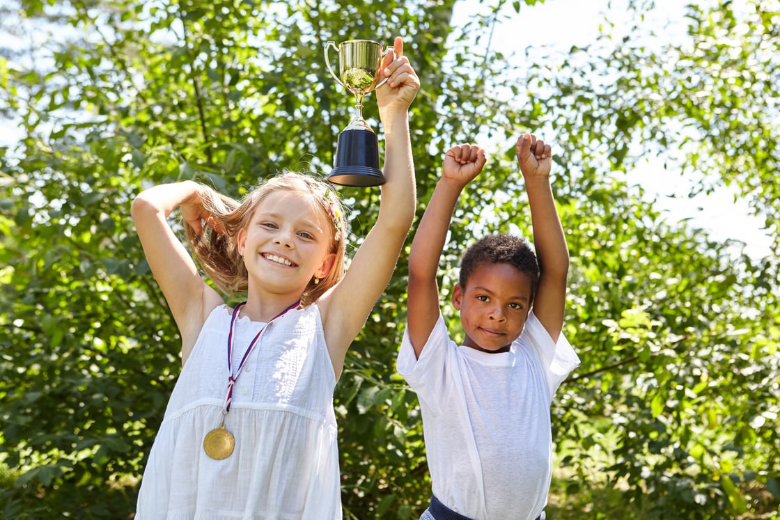 Two Children with Winner Cup and Medal